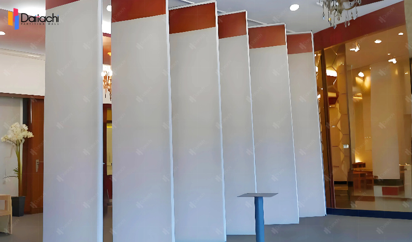 White panels in the hotel lobby with red manually movable partition walls on top White panels in the hotel lobby with red manually movable partition walls on top