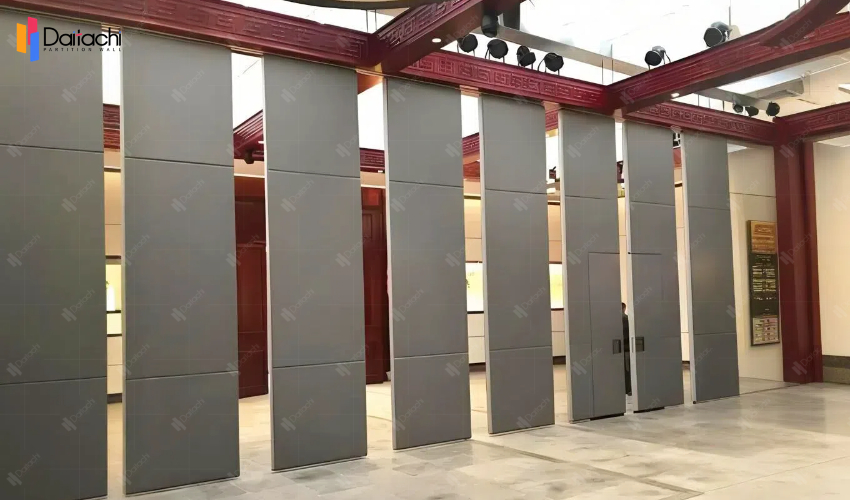 Gray manual movable partition wall with red beams Gray manual movable partition wall with red beams