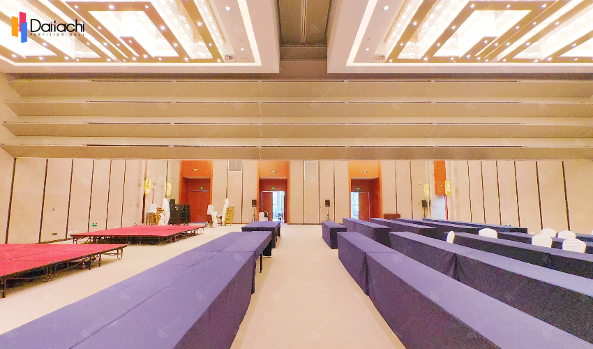 The meeting room features a minimalist, natural wood-colored vertical lifting and folding partition wall.