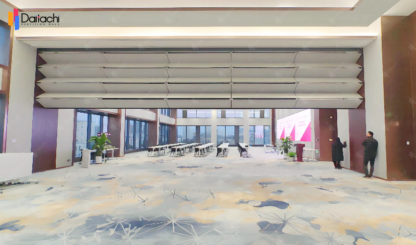The minimalist, pure white vertical lift wall in the spacious classroom