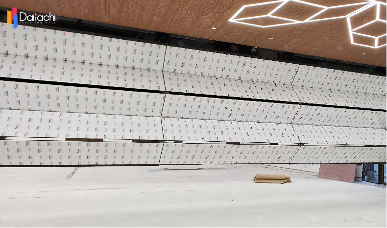 A minimalist vertical lift wall installed in an unfinished room.