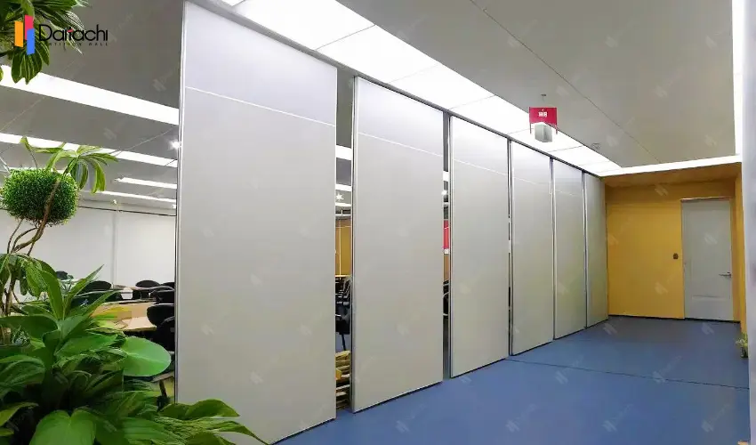 White manually movable partition wall with blue carpet White manually movable partition wall with blue carpet