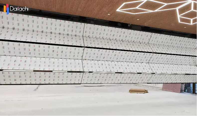 A minimalist vertical lift wall installed in an unfinished room.