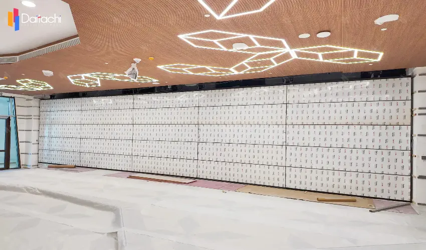 A minimalist vertical lift wall installed in an unfinished room.