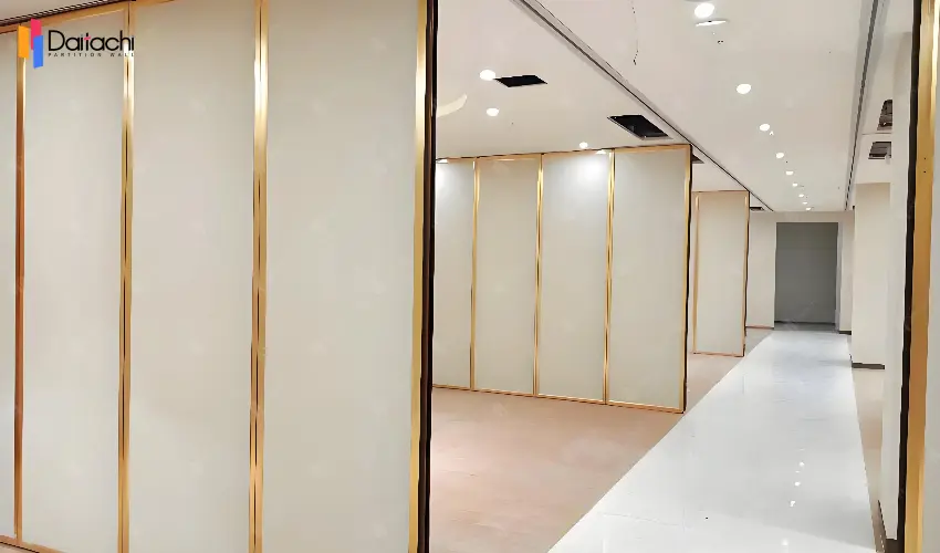 Manual movable partition wall with white panel and gold frame Manual movable partition wall with white panel and gold frame