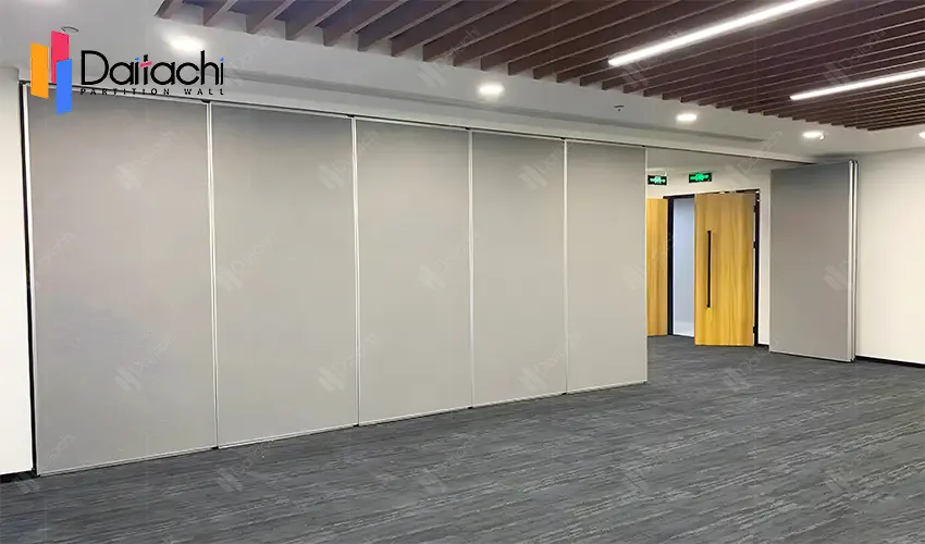 the grey manual movable partition wall in the meeting room